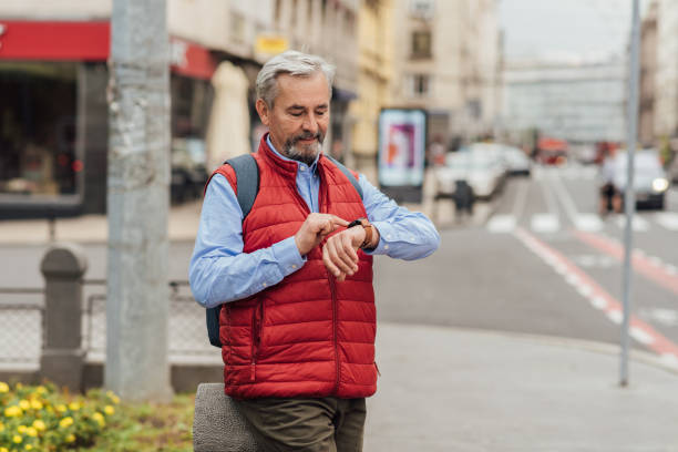 istock Senior man checking the time on the street 1278077946
