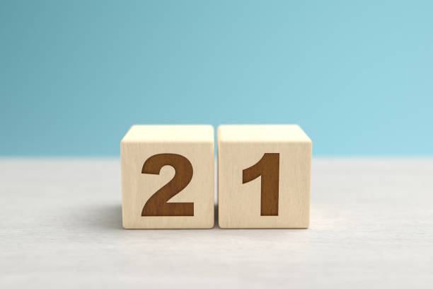 istock Wooden toy blocks forming the number 21. 1278080410