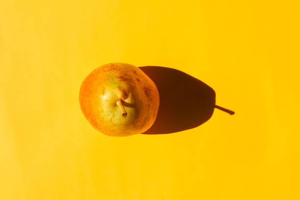 istock pear with a hard shadow on a plain background. the view from the top. blank for the pattern 1278083980