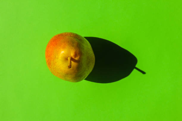 istock pear with a hard shadow on a plain background. the view from the top. blank for the pattern 1278084113