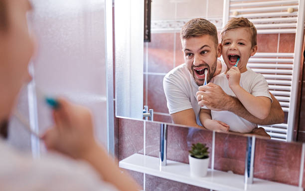 istock Father And Cute Son Brushing Teeth In The Morning 1278086991