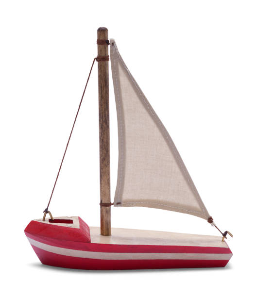 Wood Sail Boat Model Side View Red Wood Toy Sailboat Model Side View Isolated on White. toy boat stock pictures, royalty-free photos & images