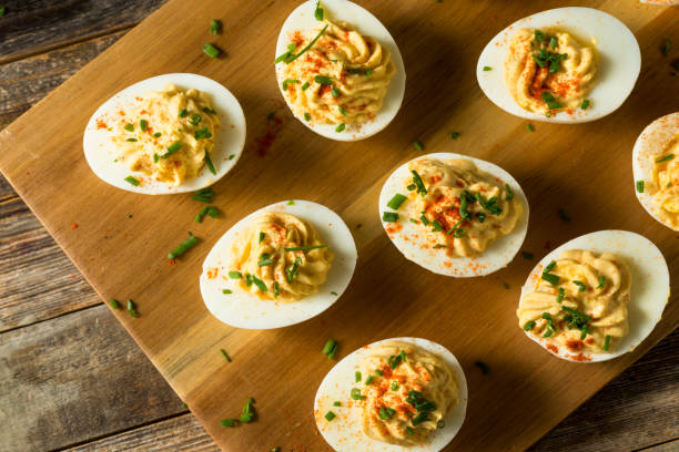 Cooked Organic Hard Boiled Eggs Cooked Organic Hard Boiled Eggs with Chives and Paprika Deviled Egg stock pictures, royalty-free photos & images
