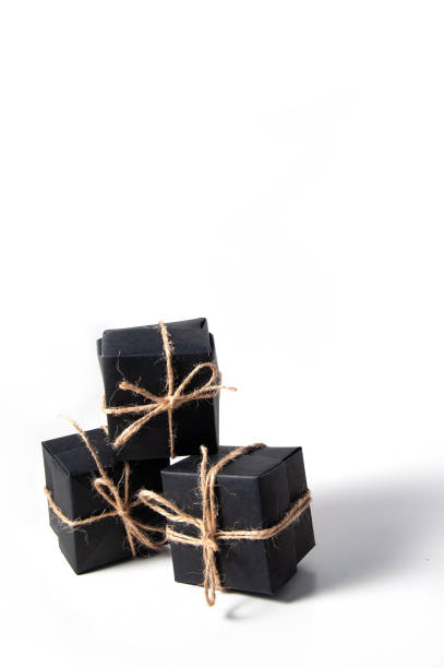 istock Pyramid of black handmade gift boxes tied with craft thread. 1278099114