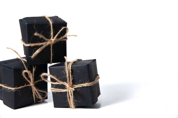 istock Pyramid of black handmade gift boxes tied with craft thread. 1278099127