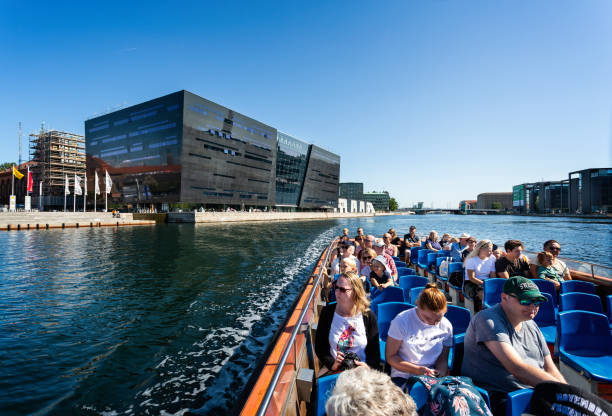 The Royal Library or Black Diamond iconic building on the waterfront  viewed from a canal boat sightseeing tour in Copenhagen, Denmark stock photo