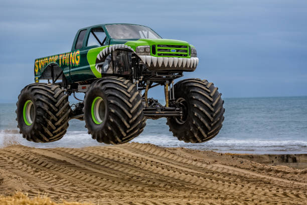 caminhão monstro aéreo na praia tomada em bournemouth, dorset, reino unido - british racing green - fotografias e filmes do acervo