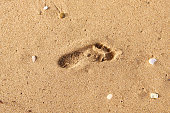 Step one foot on the sand during sunrise - Golden sunrise - footprints in the sand - footprints on the beach - travel restrictions