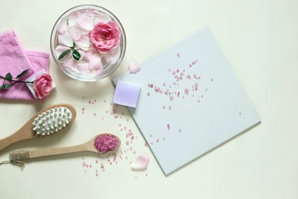 istock Fresh pink roses, water, petals, candles on a light background 1278106846