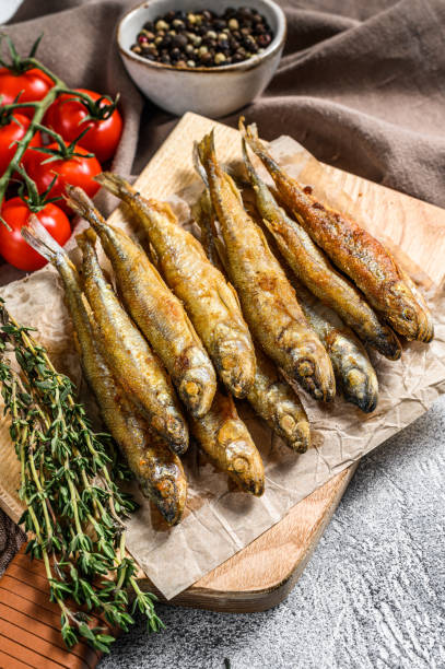 istock Grilled smelt fish. Delicious appetizer. Gray background. Top view 1278112082