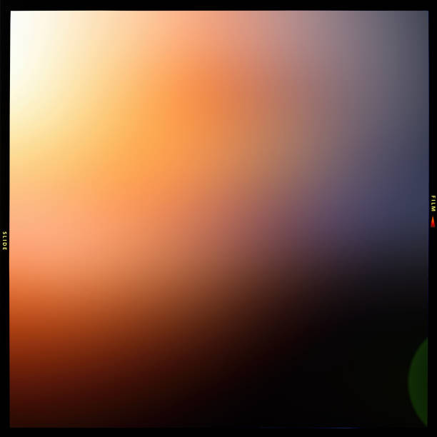 istock Blurred abstract colored orange and gray, black background in a black frame along the contour, slide film. 1278112639