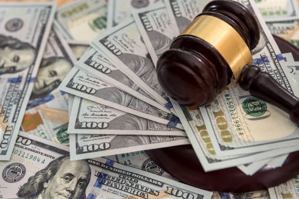 istock Many hundred dollar bills with judge gavel 1278113414