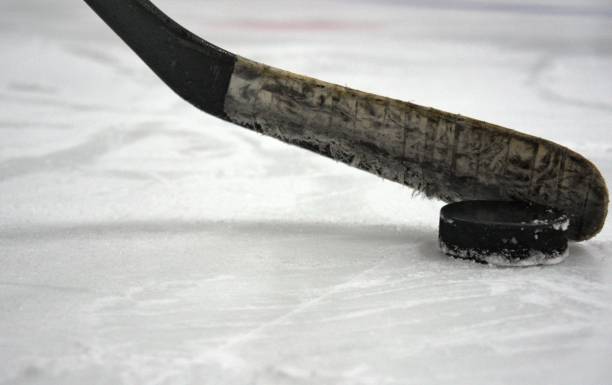 istock hockey stick with puck 1278118241