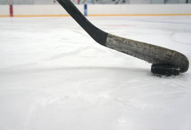 istock hockey stick with puck 1278118242