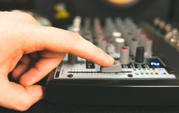 istock Sound engineer using main control fader of studio mixer. 1278126375
