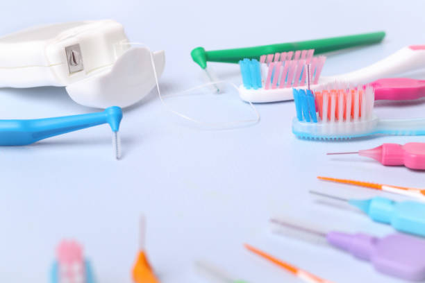 istock Different toothbrushes and dental floss on blue, close up. 1278133150