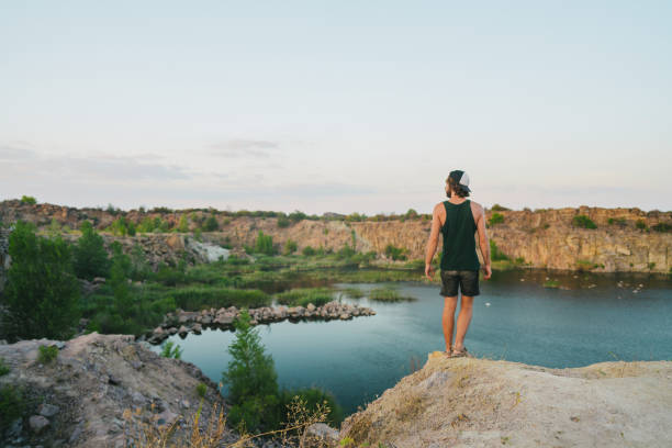 istock Man looking at scenic lake at sunset 1278133340