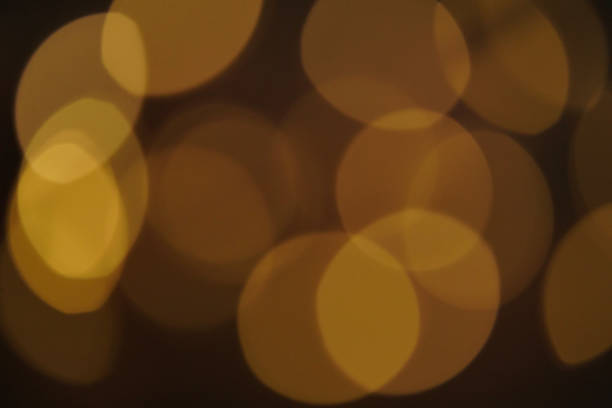 istock Christmas lights in bokeh. Blurred Christmas lights background texture,defocused illumination as background. Bright yellow circles on a black background, abstract background 1278133667