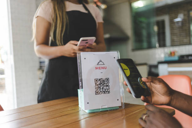 Customer scanning QR code to view food menu online Customer scanning QR code to view food menu online apron photos stock pictures, royalty-free photos & images