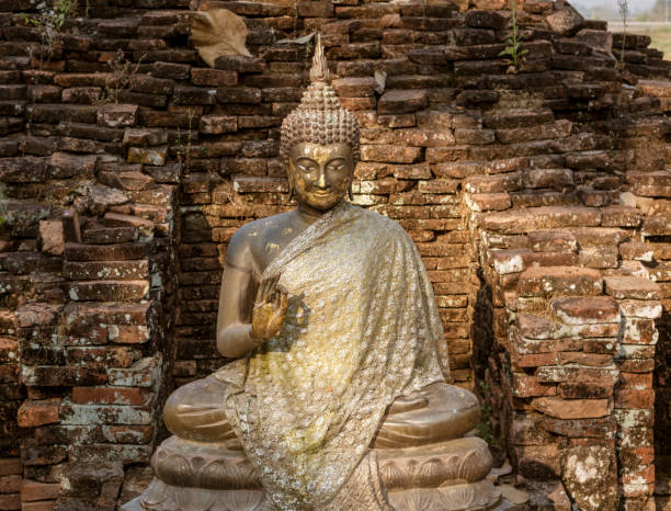 istock Sitting Stone Buddha in an Ancient Brick Alcove 1278141449