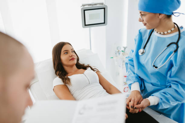 istock Doctors talking to young patient in hospital bed 1278162059