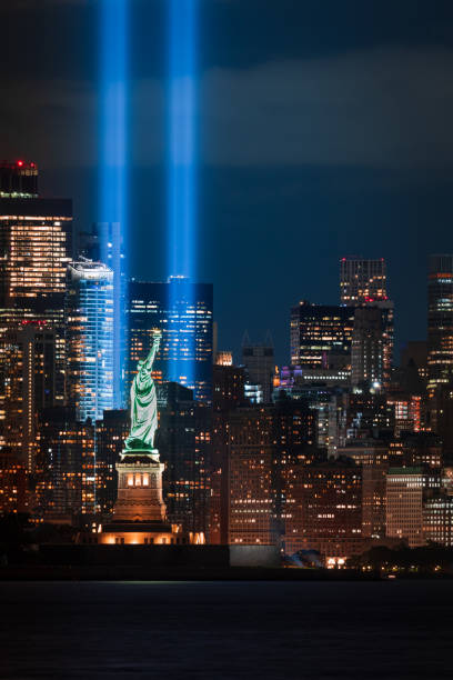 New Jersey - September 11, 2020, The Tribute in Light 9/11 memorial with the Statue of Liberty. New York City, USA