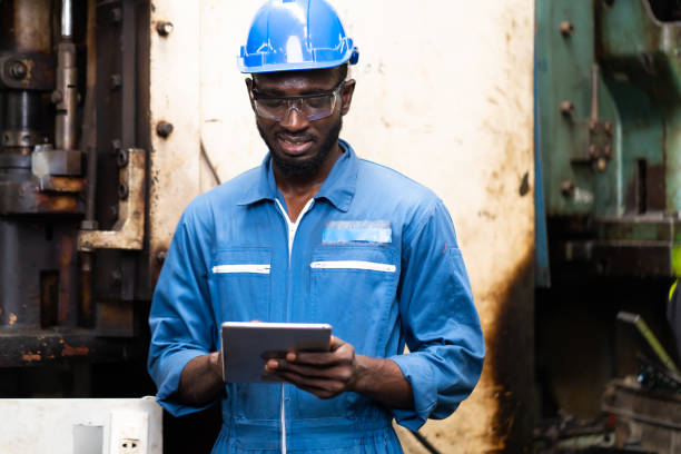istock Black Male Engineer Working on machine in Factory. black man engineer checking Quality control the condition of the machine 1278175062