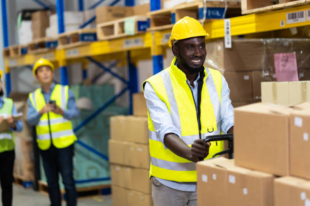 istock Black Male warehouse worker pulling a pallet truck. middle aged African American warehouse worker preparing a shipment 1278175080