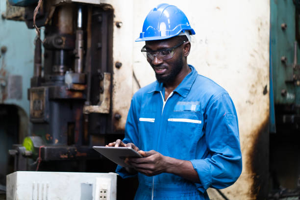 istock Male Engineer Working on digital tablet in Factory. black male engineer checking Quality control the condition of the machine 1278175112