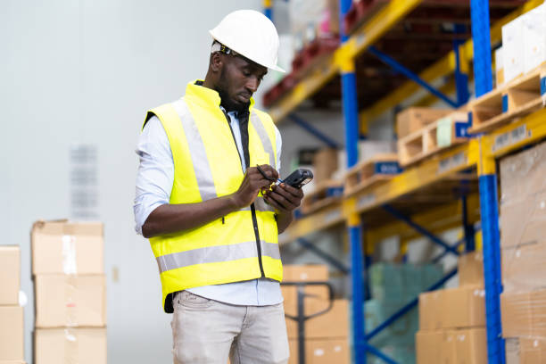 istock Black Male warehouse worker pulling a pallet truck. middle aged African American warehouse worker preparing a shipment 1278175131
