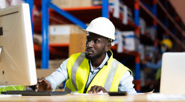 istock Black Male warehouse worker pulling a pallet truck. middle aged African American warehouse worker preparing a shipment 1278175242