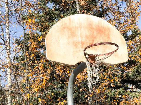 A basketball hoop stands after years of use. On this fall day in Interior Alaska, it stands ready for all to play.