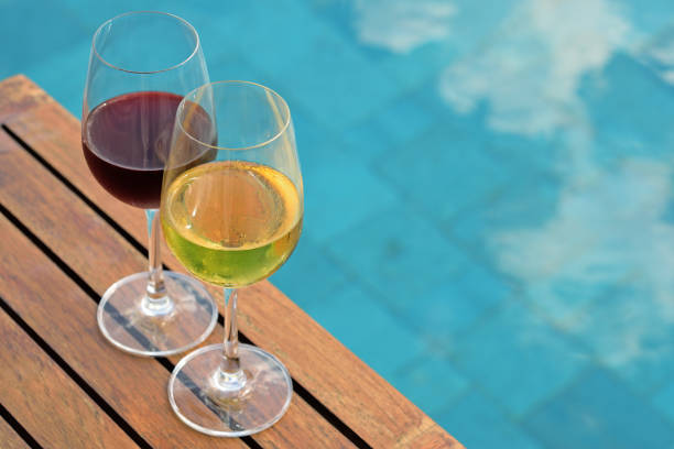 istock Two glasses of wine on wooden table 1278187749