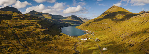 Faroe Islands Funningsfjordur Majestic Fjord Panorama Eysturoy Island Panorama of Funningsfjordur Fjord and surrunding Funningsfjørður Mountain Range in summer under blue summer cloudscape with fluffy clouds. XXL Aerial Eysturoy Island - Faroe Islands Panorama. Funningsfjørður - Funningsfjordur Fjord, East Coast of Eysturoy Island, Faroe Islanda, Kingdom of Denmark, Nordic Countries, Europe. eysturoy photos stock pictures, royalty-free photos & images
