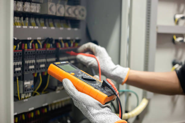 istock Electrician engineer uses a multimeter to test the electrical installation and power line current in an electrical system control cabinet. 1278207197