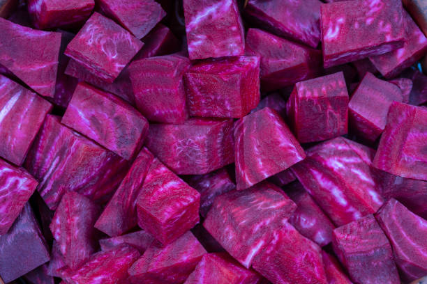 istock Fresh segments of a red beetroot, closeup. Purple beet slices background, top view 1278208256