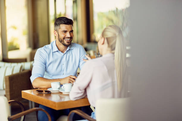 istock Happy man talking to his girlfriend while relaxing in a cafe. 1278211151