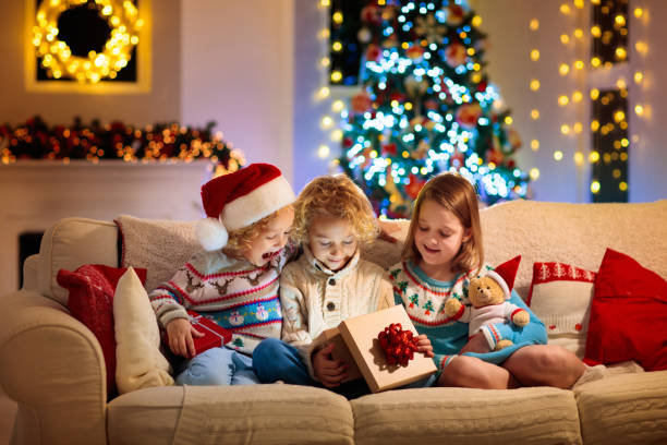 istock Child at Christmas tree. Kids at fireplace on Xmas 1278213813