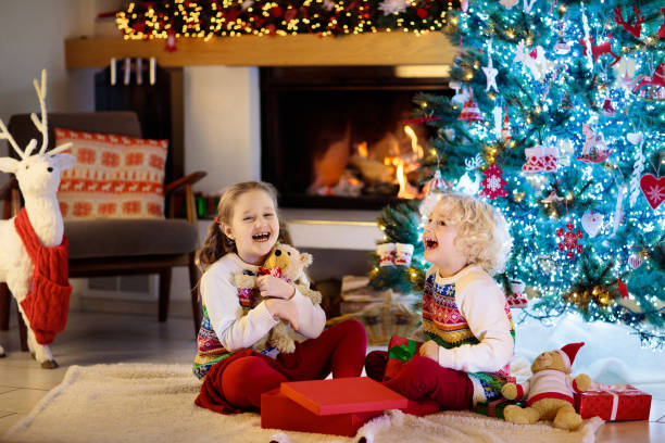 istock Child at Christmas tree. Kids at fireplace on Xmas 1278213845