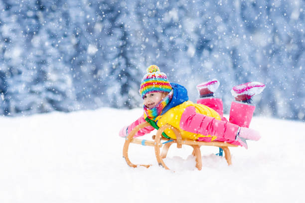 istock Girl on sleigh ride. Child sledding. Kid with sledge 1278217128