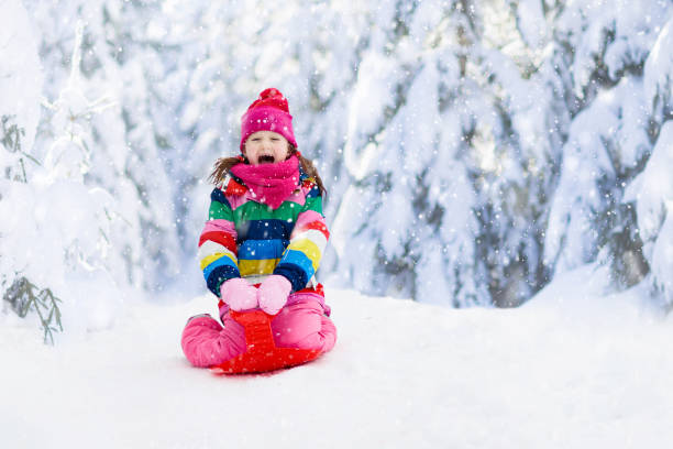 istock Girl on sled ride. Child sledding. Kid on sledge 1278217185