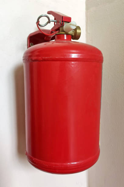 istock Red fire extinguisher mounted to a gray wall. Fire extinguishers available in fire emergencies 1278219853