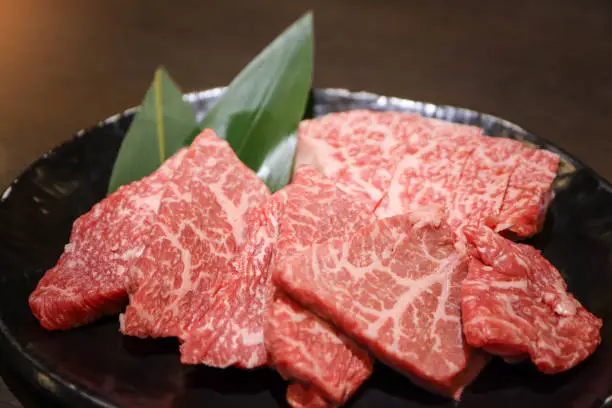 Premium quality raw sliced Wagyu beef A5 steak in the black plate for Yakiniku. Japanese foods style.