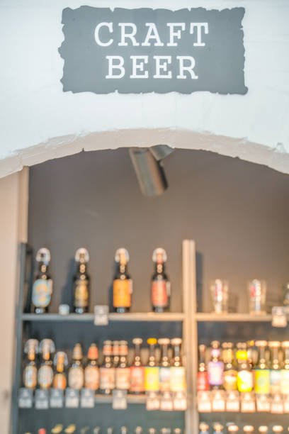 Shelves with craft beer in the store, blurry background