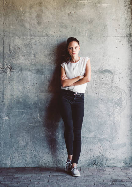istock Confident woman with arms crossed against wall 1278227202