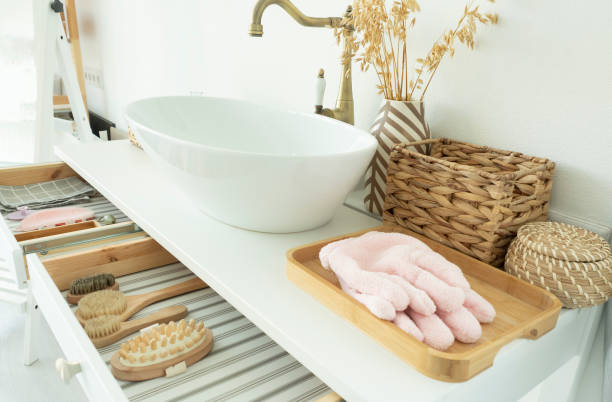 istock bright bathroom. drawn out drawers with massagers and brushes. wicker baskets and sink. 1278228527