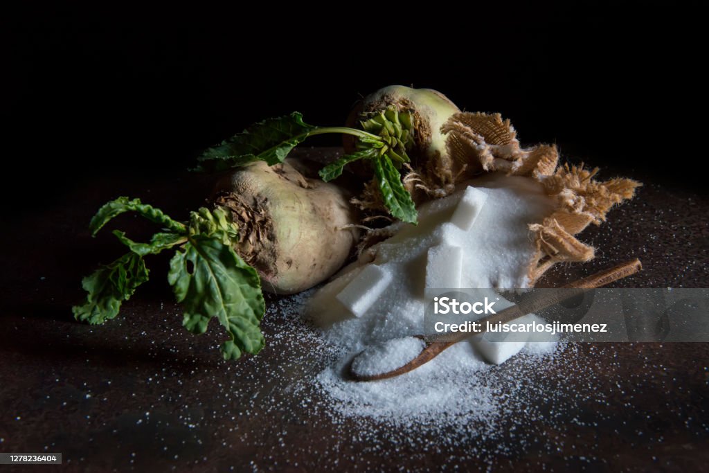 sugar beet and white sugar with rust background Sugar - Food Stock Photo