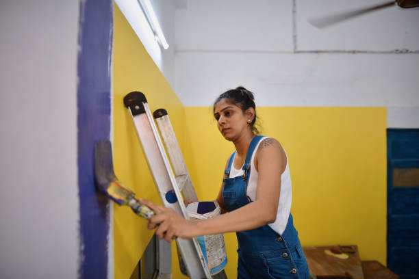 istock Woman coloring interiors of her workshop 1278237767