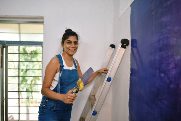 istock Woman coloring interiors of her workshop 1278237796