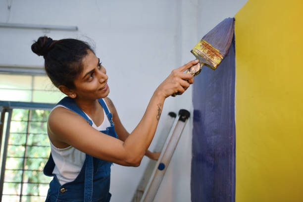 istock Woman coloring interiors of her workshop 1278237817
